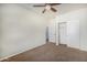 Neutral bedroom with carpet flooring, a ceiling fan, walk-in closet and white trim at 3530 S Bandit Rd, Gilbert, AZ 85297
