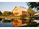 Exterior view of a charming building reflected in a pond, with well-maintained landscaping at 3530 S Bandit Rd, Gilbert, AZ 85297