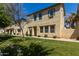 Inviting two-story home with a lush lawn, mature tree, and charming desert landscaping at 3530 S Bandit Rd, Gilbert, AZ 85297