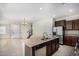 Open kitchen featuring granite counters, stainless appliances, tile floors, and an island sink at 3530 S Bandit Rd, Gilbert, AZ 85297