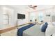 Bedroom with a ceiling fan, two windows, and a view into the main bath at 3530 S Bandit Rd, Gilbert, AZ 85297