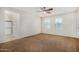 Spacious main bedroom with carpet, a ceiling fan, and an ensuite bathroom at 3530 S Bandit Rd, Gilbert, AZ 85297