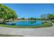 Scenic pond reflecting the clear blue sky, complemented by lush green landscaping and walking paths at 3530 S Bandit Rd, Gilbert, AZ 85297