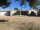 Large backyard featuring a covered patio, brick accents, and low-maintenance landscaping at 3539 W Davidson Ln, Phoenix, AZ 85051