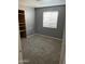 Bedroom features neutral carpet, fresh paint, a window with blinds and a closet with built-in shelving at 3539 W Davidson Ln, Phoenix, AZ 85051