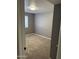 Cozy bedroom featuring neutral gray walls, plush carpeting, and a bright window at 3539 W Davidson Ln, Phoenix, AZ 85051
