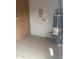Functional utility area with a water heater, tiled floor, and electrical panel at 3539 W Davidson Ln, Phoenix, AZ 85051