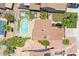 Aerial view of a backyard featuring a sparkling pool, a playful checkerboard lawn, and lush landscaping at 3608 W Harrison St, Chandler, AZ 85226