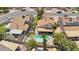 Aerial view featuring houses with lush lawns, a backyard pool, and a quiet residential street at 3608 W Harrison St, Chandler, AZ 85226
