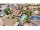 High-angle shot of properties with lush landscaping, including a pool and checkerboard lawn at 3608 W Harrison St, Chandler, AZ 85226