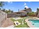 Backyard with bench seating area, artificial grass, and pavers forming a checkerboard design at 3608 W Harrison St, Chandler, AZ 85226