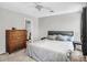 Bedroom featuring a queen size bed, carpet, wooden dresser, and neutral grey decor at 3608 W Harrison St, Chandler, AZ 85226