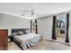 Bedroom featuring a queen size bed, carpet, two windows, and neutral grey decor at 3608 W Harrison St, Chandler, AZ 85226