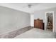 Bedroom featuring a queen size bed, carpet, wooden dresser, and neutral grey decor at 3608 W Harrison St, Chandler, AZ 85226