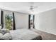 Bedroom featuring a queen size bed, carpet, two windows, and neutral grey decor at 3608 W Harrison St, Chandler, AZ 85226