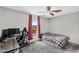 Cozy bedroom with twin bed, ceiling fan, desk, and bright window for natural light at 3608 W Harrison St, Chandler, AZ 85226