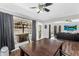 Bright dining area with dark wood floors, table, ceiling fan, and sliding glass doors to backyard with a pool at 3608 W Harrison St, Chandler, AZ 85226