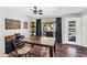 Bright dining room area showcasing hardwood floors, a dark wooden table, and sliding glass door access to the backyard pool at 3608 W Harrison St, Chandler, AZ 85226