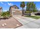 Beige two-story home featuring a two-car garage, manicured lawn, palm trees, and a driveway, set against a blue sky at 3608 W Harrison St, Chandler, AZ 85226