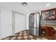 Kitchen featuring stainless steel refrigerator, tiled backsplash, checkered floors, and ample storage space at 3608 W Harrison St, Chandler, AZ 85226