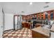 Classic kitchen boasting wooden cabinets, stainless steel appliances, checkered floors, and ample counter space for cooking at 3608 W Harrison St, Chandler, AZ 85226