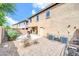 View of a home's backyard with neutral colored stone landscaping, patio, and a grill at 3745 E Flamingo Way, Gilbert, AZ 85297