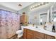 Bright bathroom featuring a shower curtain, storage, and an easily accessible toilet at 3745 E Flamingo Way, Gilbert, AZ 85297