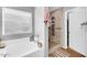 Bathroom featuring a soaking tub, stand-up shower, and large window at 3745 E Flamingo Way, Gilbert, AZ 85297