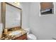 Well-lit bathroom with granite countertops, an ornate mirror, and modern fixtures at 3745 E Flamingo Way, Gilbert, AZ 85297