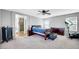 Spacious bedroom with plush carpet, ceiling fan, and natural light at 3745 E Flamingo Way, Gilbert, AZ 85297