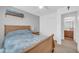 Bedroom featuring wood bed frame, a closet with sliding doors, and a bathroom through doorway at 3745 E Flamingo Way, Gilbert, AZ 85297