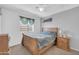 Comfortable bedroom with a wood bed frame, ceiling fan, and window with blinds, creating a cozy, inviting space at 3745 E Flamingo Way, Gilbert, AZ 85297