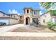 Charming two-story home featuring a front yard with decorative gravel and a welcoming entrance with a decorated door at 3745 E Flamingo Way, Gilbert, AZ 85297