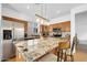Bright kitchen featuring granite counters, stainless steel appliances, and wood cabinets at 3745 E Flamingo Way, Gilbert, AZ 85297