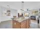 A kitchen island featuring granite countertops and wooden cabinets at 3745 E Flamingo Way, Gilbert, AZ 85297