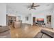 Open-concept living room with tile floors flows into the kitchen with an island, and a ceiling fan at 3745 E Flamingo Way, Gilbert, AZ 85297