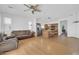 Open-concept living room with wood floors flows into the kitchen with an island, and a ceiling fan at 3745 E Flamingo Way, Gilbert, AZ 85297