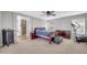 Spacious primary bedroom with ceiling fan, ensuite bathroom, dark wood furniture, and neutral color palette at 3745 E Flamingo Way, Gilbert, AZ 85297