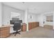 Bright office space featuring a built-in desk, an ergonomic chair, and ample storage cabinets at 3745 E Flamingo Way, Gilbert, AZ 85297