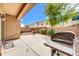 Covered patio with space for entertaining, overlooking landscaped backyard with grill at 3745 E Flamingo Way, Gilbert, AZ 85297