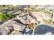 Aerial view of an attractive desert home with a pool, putting green and solar panels at 42318 W Abbey Rd, Maricopa, AZ 85138
