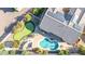 Aerial view of a house featuring a backyard putting green, pool, and manicured landscaping at 42318 W Abbey Rd, Maricopa, AZ 85138