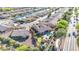 Aerial shot showcasing a home's backyard putting green, pool, and neighborhood bordering a canal at 42318 W Abbey Rd, Maricopa, AZ 85138