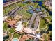 Aerial view of a vibrant community with pools, tennis courts, and manicured green spaces at 42318 W Abbey Rd, Maricopa, AZ 85138