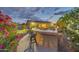 Inviting backyard features a built-in bar, putting green, and colorful landscaping at 42318 W Abbey Rd, Maricopa, AZ 85138