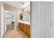 Bright bathroom with double vanity and mirrors, with access to a walk-in closet at 42318 W Abbey Rd, Maricopa, AZ 85138