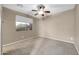 Bedroom features a ceiling fan and a large window with a blinds at 42318 W Abbey Rd, Maricopa, AZ 85138