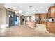 Spacious kitchen with an island, wood cabinets and a sliding door that leads to the backyard at 42318 W Abbey Rd, Maricopa, AZ 85138