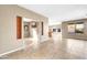 Spacious living area with tile flooring, tan walls, and natural light highlighting the open layout at 42318 W Abbey Rd, Maricopa, AZ 85138