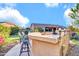 Outdoor bar featuring seating and a putting green, perfect for entertaining and relaxation at 42318 W Abbey Rd, Maricopa, AZ 85138
